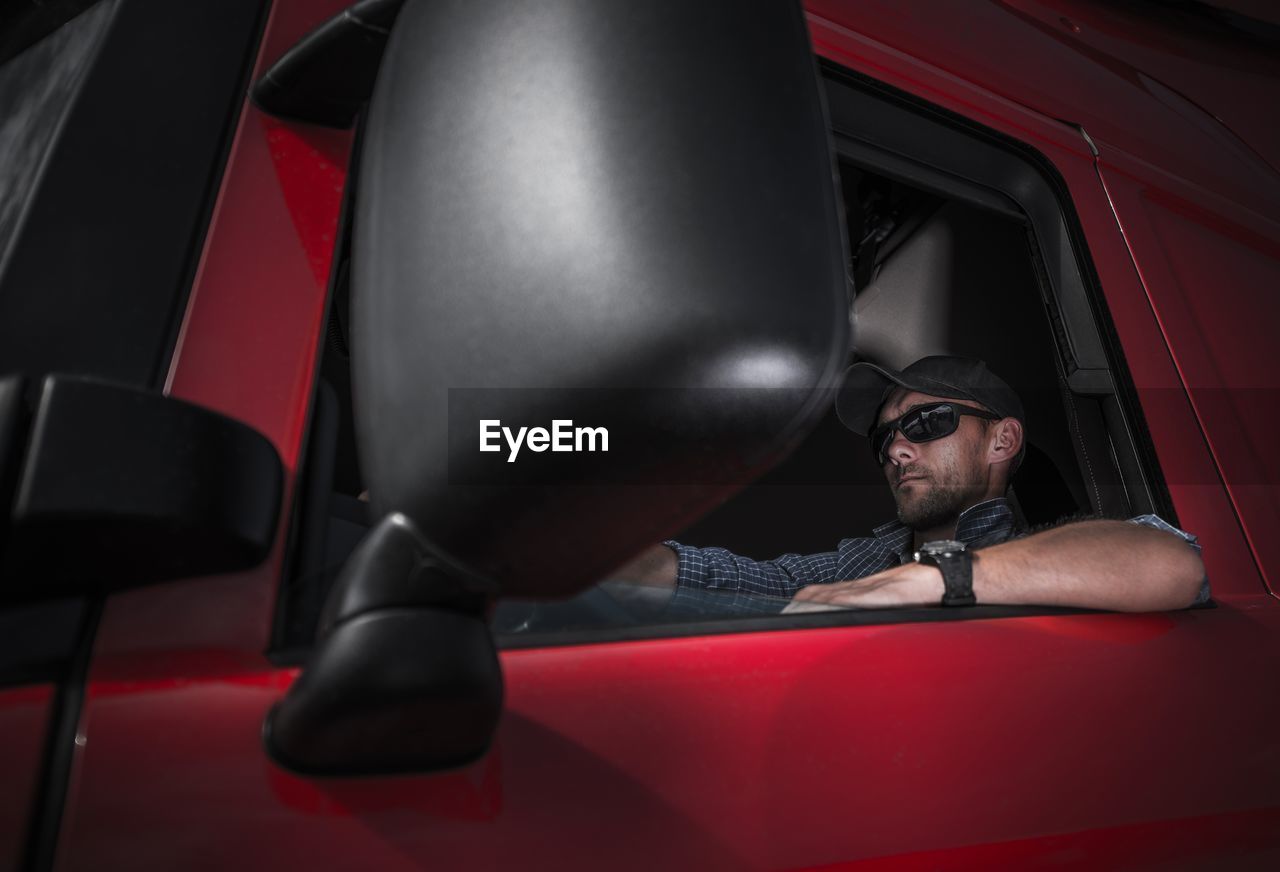 Low angle view of man sitting in vehicle