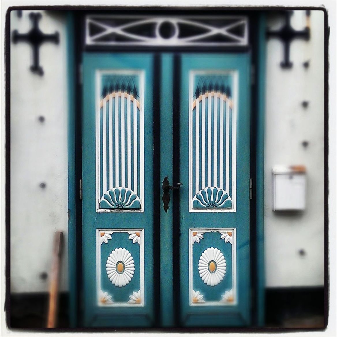 Tilt-shift image of blue door on house