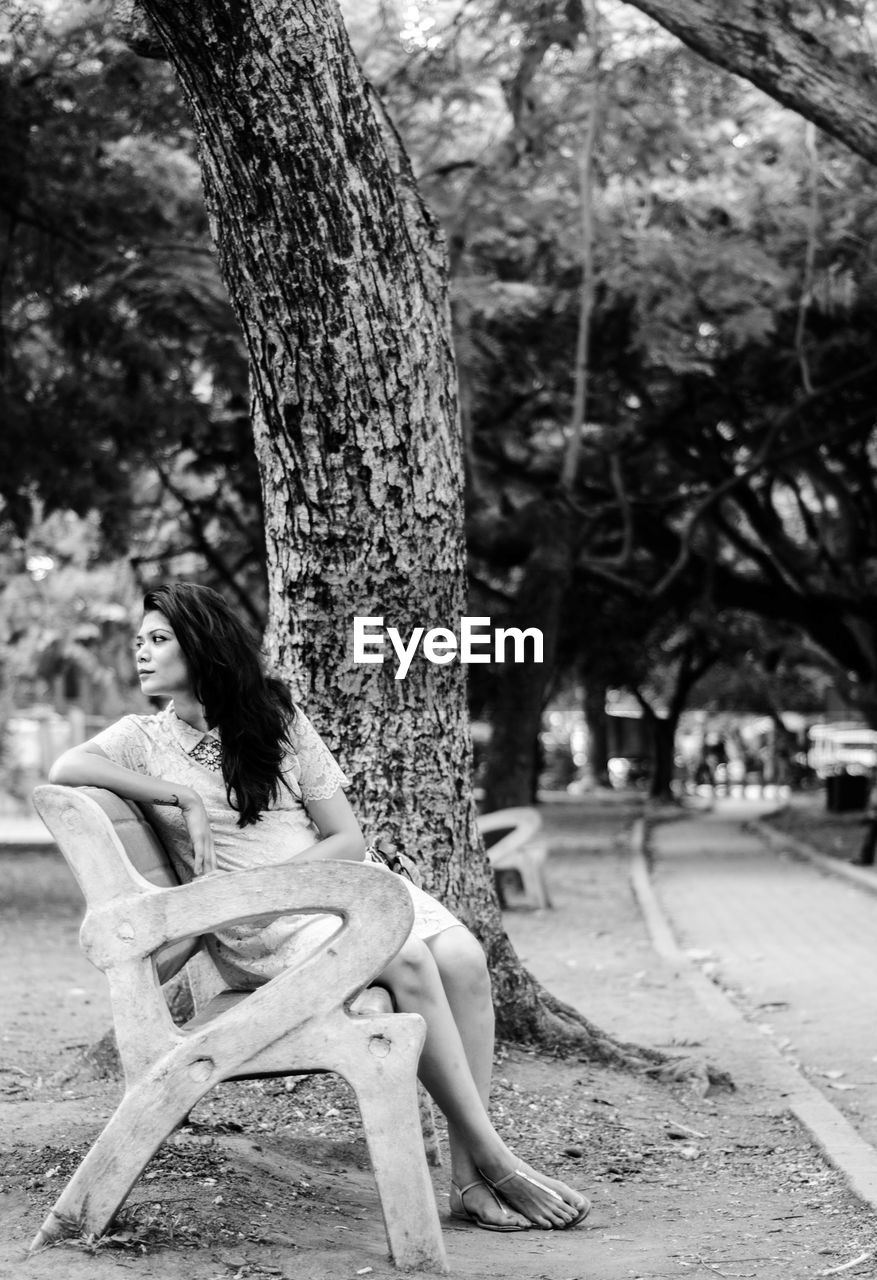 Woman sitting on bench at park