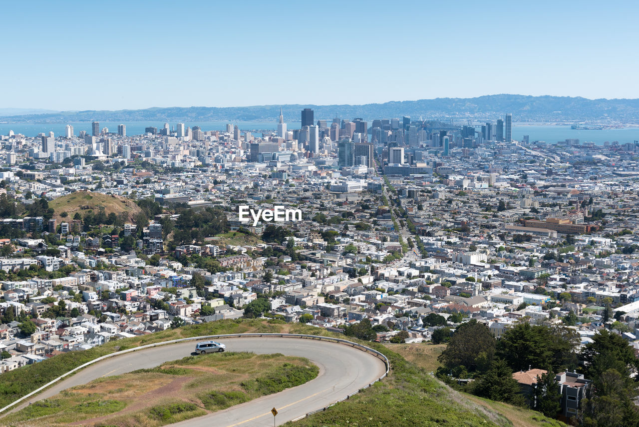 High angle view of city buildings against clear sky