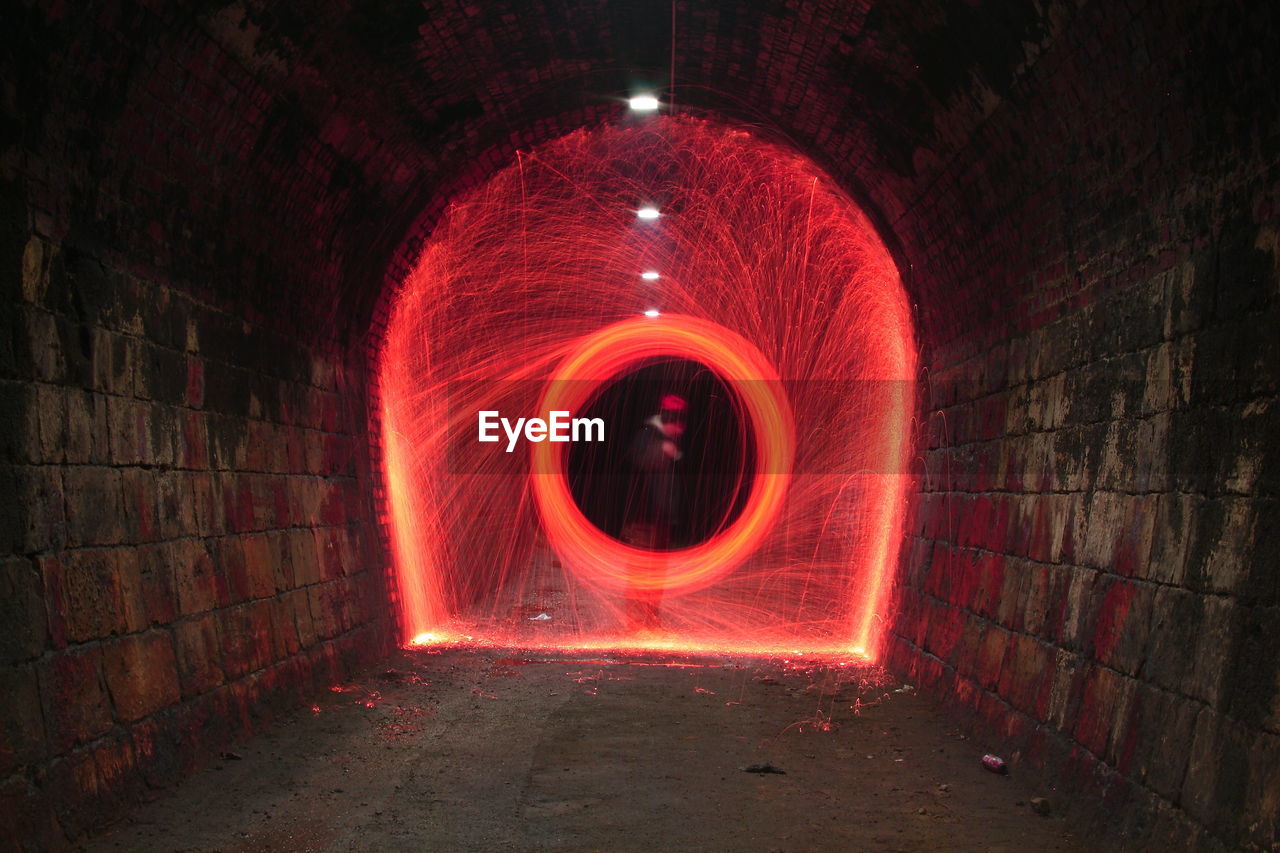 Red wire wool spinning in tunnel at night