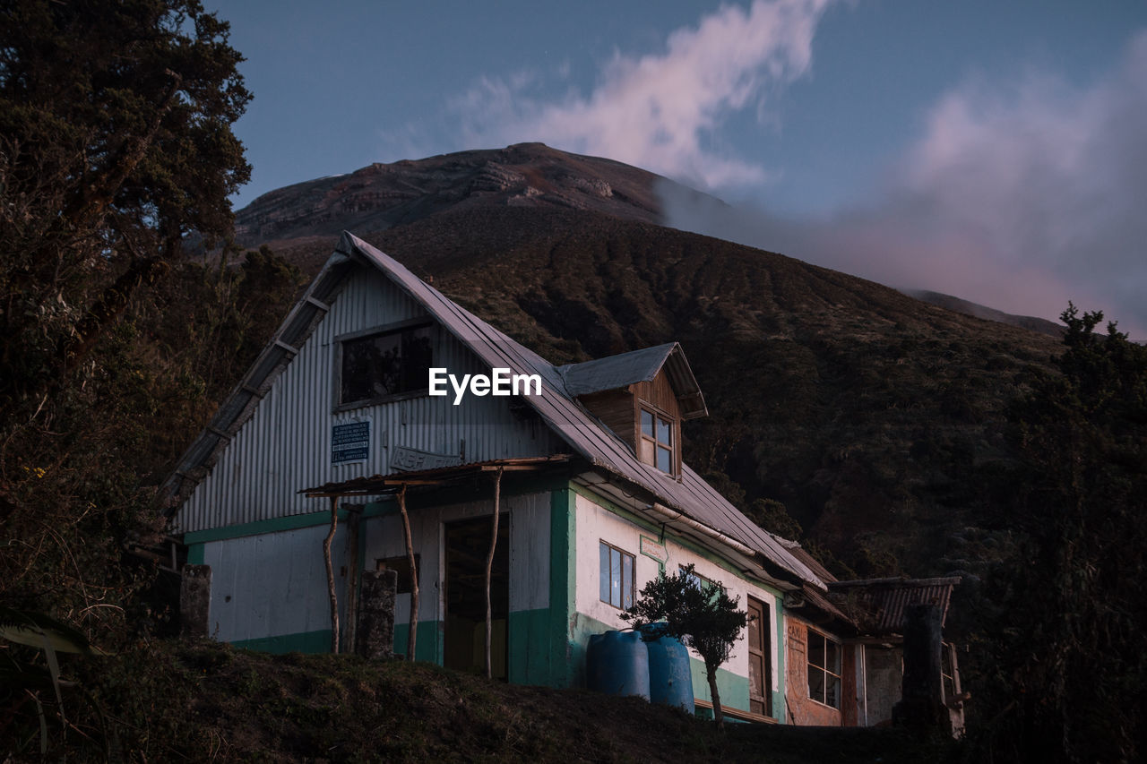 HOUSE ON MOUNTAIN BY ROAD AGAINST SKY