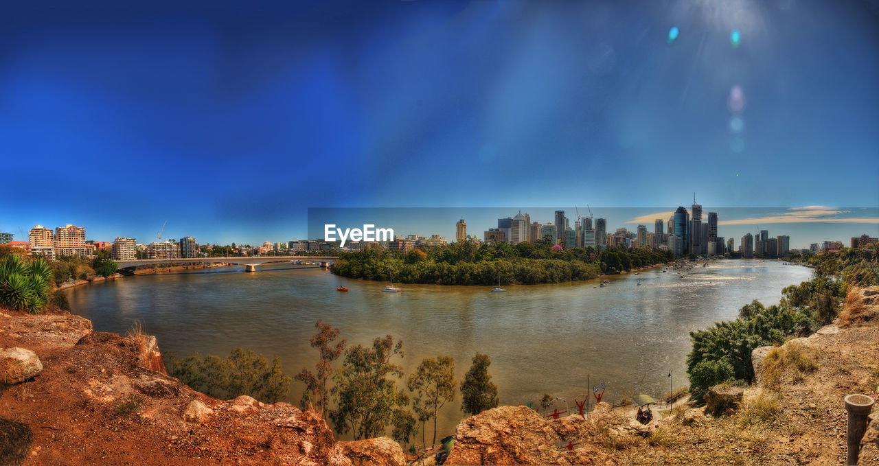 Panoramic view of buildings against cloudy sky