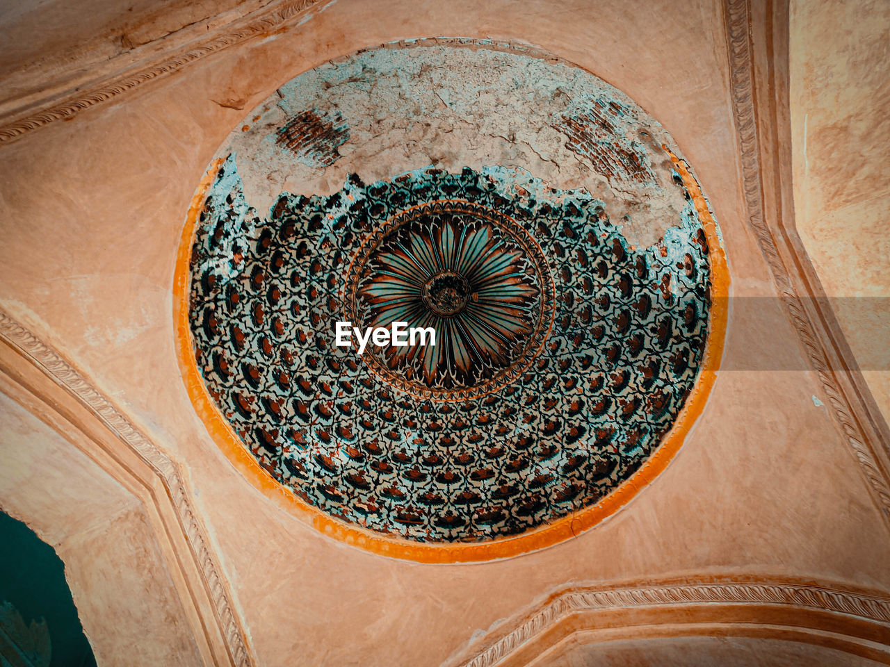 DIRECTLY BELOW SHOT OF ORNATE CEILING ON TILED WALL