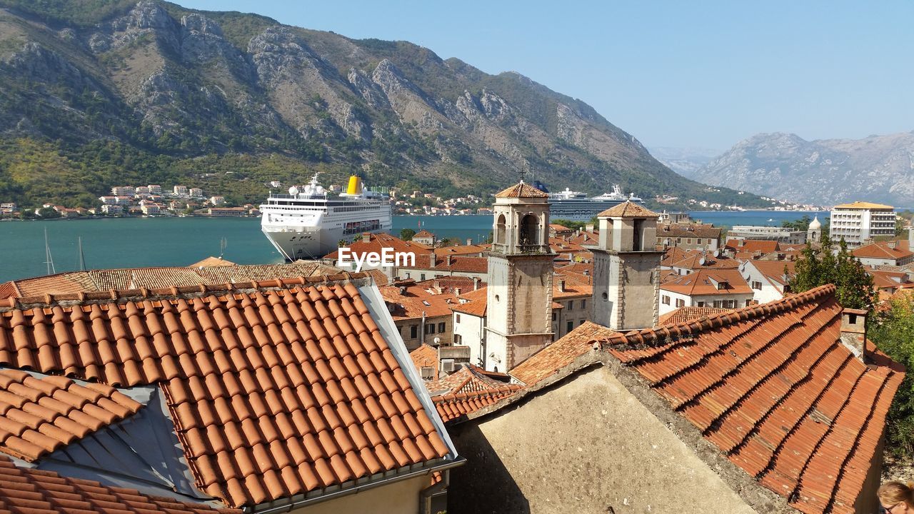 Townscape by sea against sky