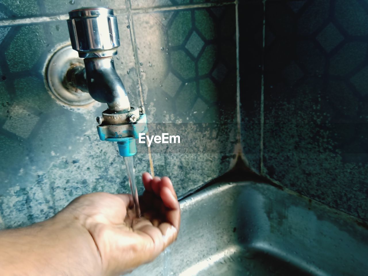 Close-up of person washing hand
