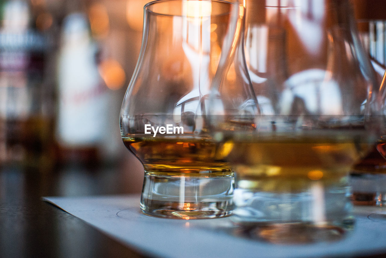 Close-up of scotch whiskey glasses on table