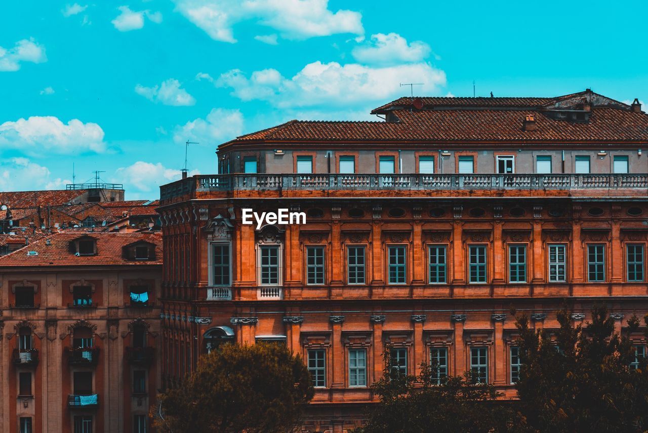 Low angle view of building against cloudy sky