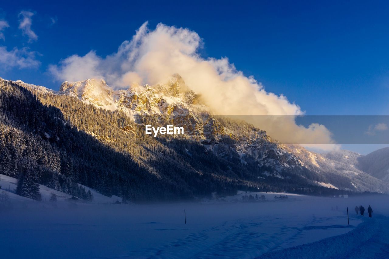 Scenic view of mountains against sky during winter