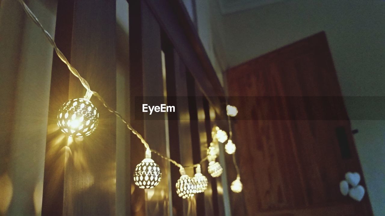 Low angle view of illuminated lighting decoration in house