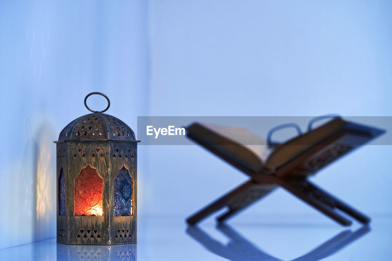 Arabic lantern and koran on wood stand