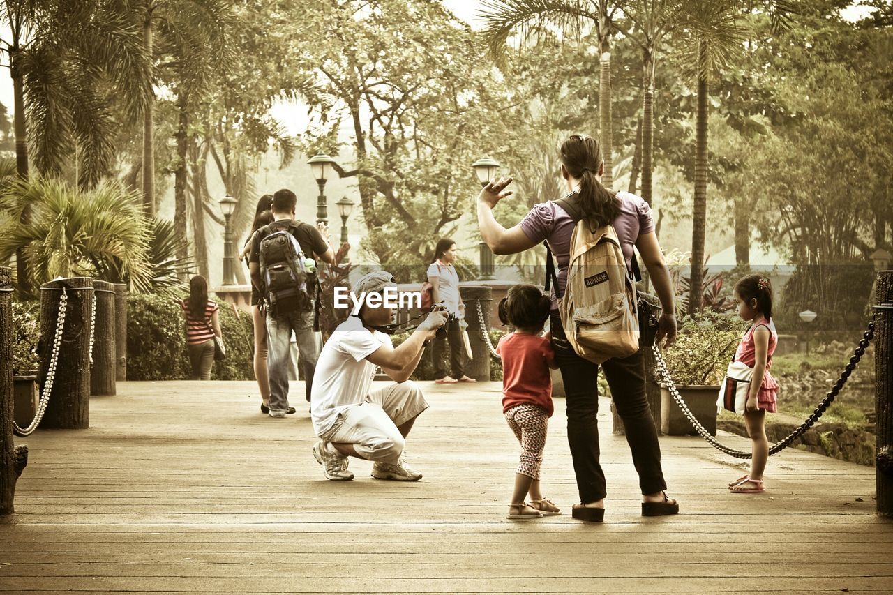 PEOPLE STANDING ON TREE