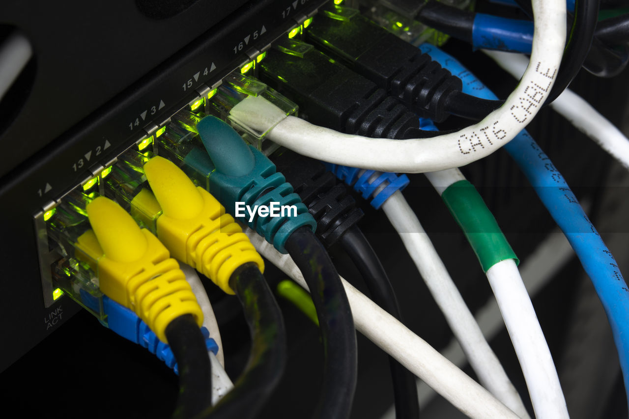 Close-up network equipment in server room and ethernet utp cat6 installed in the rack.