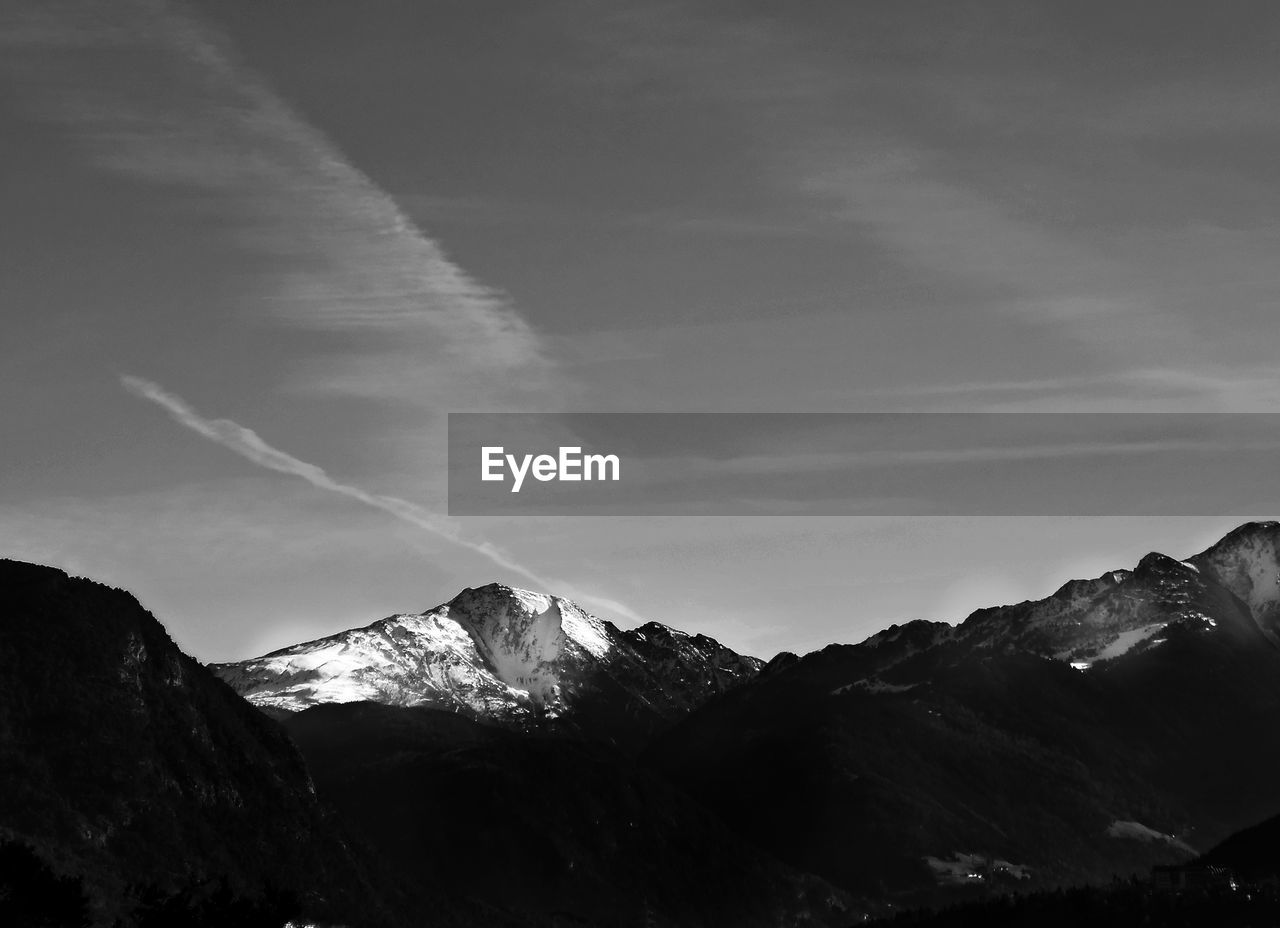 Scenic view of mountains against cloudy sky