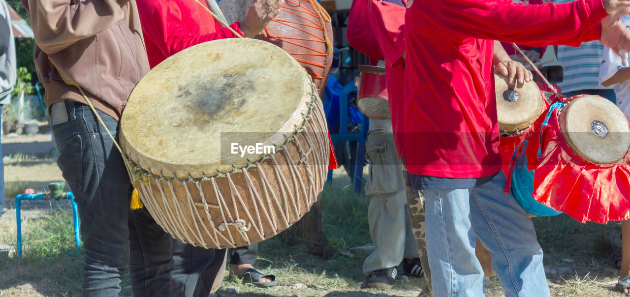 Midsection of people playing musical instruments