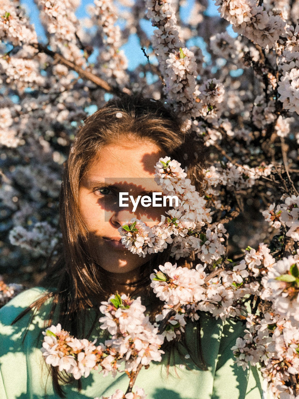 Portrait of young woman with cherry blossom