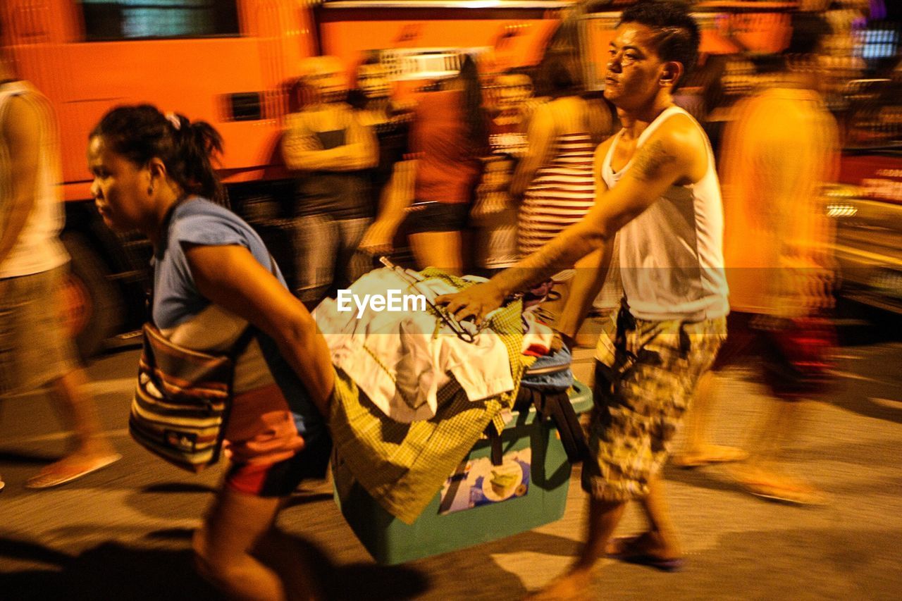 REAR VIEW OF PEOPLE ON STREET