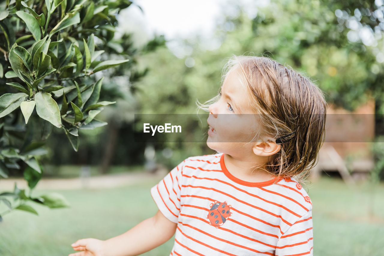 Portrait of girl looking at plants