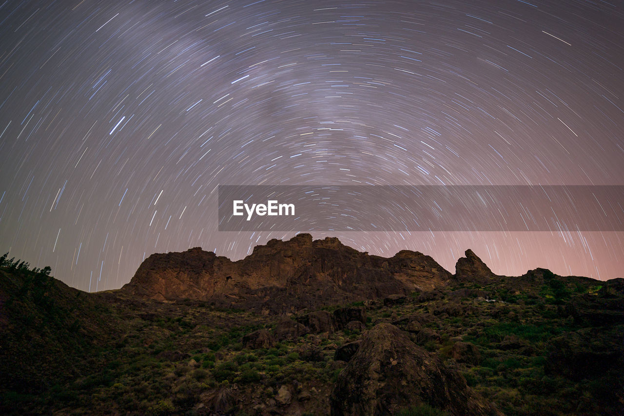 Scenic view of mountains against sky at night