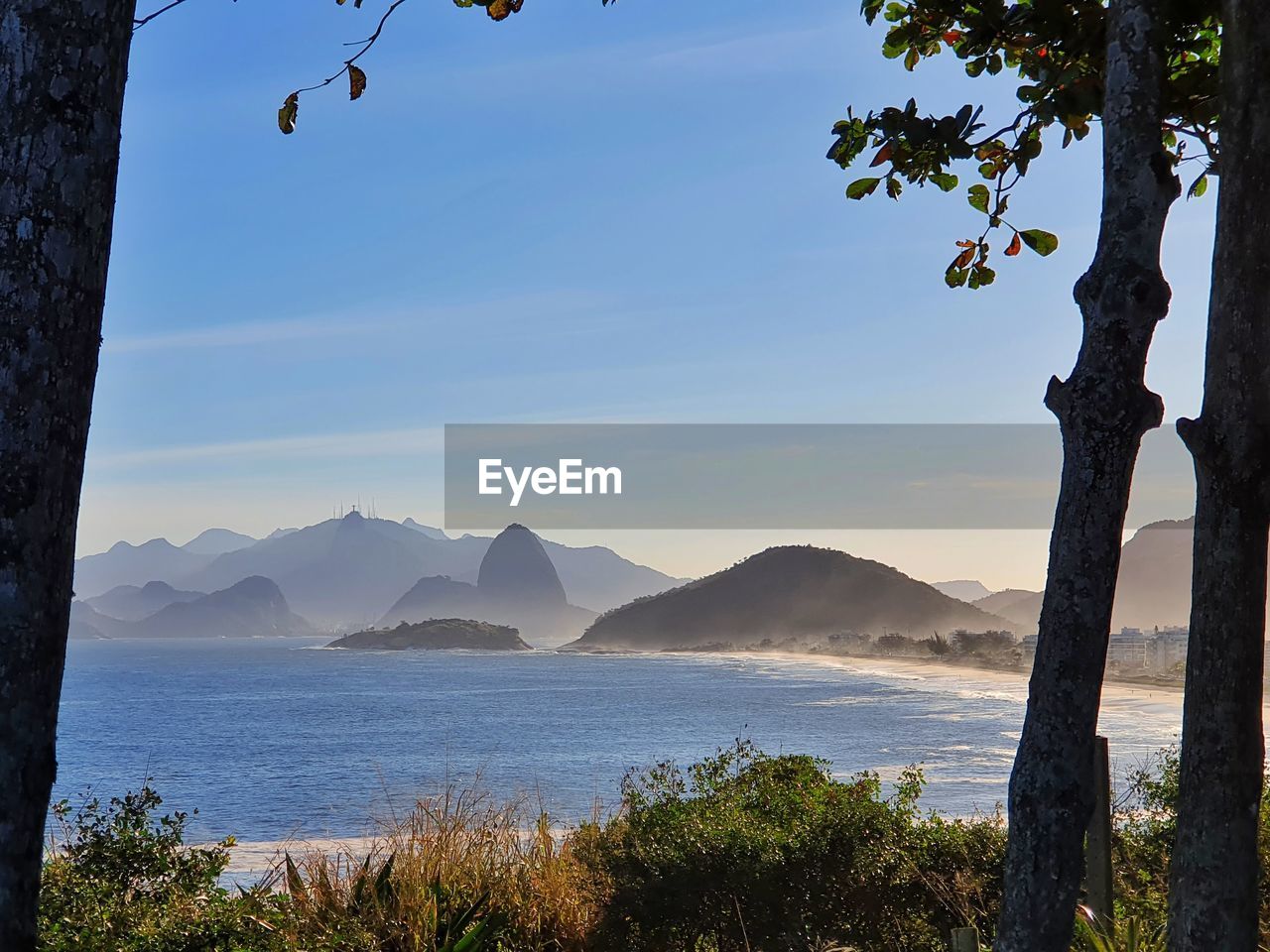 SCENIC VIEW OF SEA AGAINST MOUNTAINS