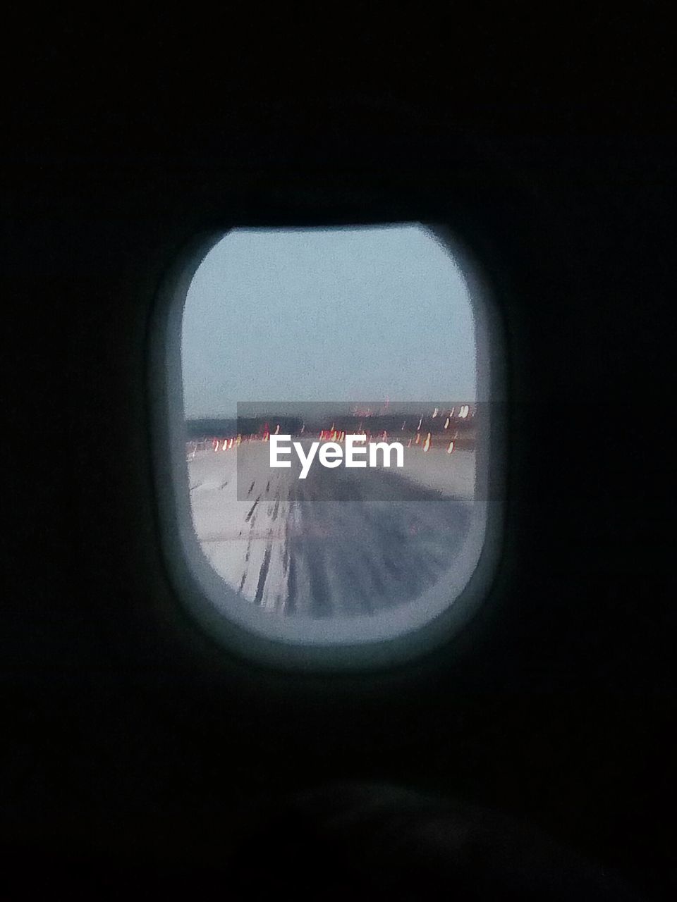 VIEW OF AIRPLANE WING THROUGH WINDOW