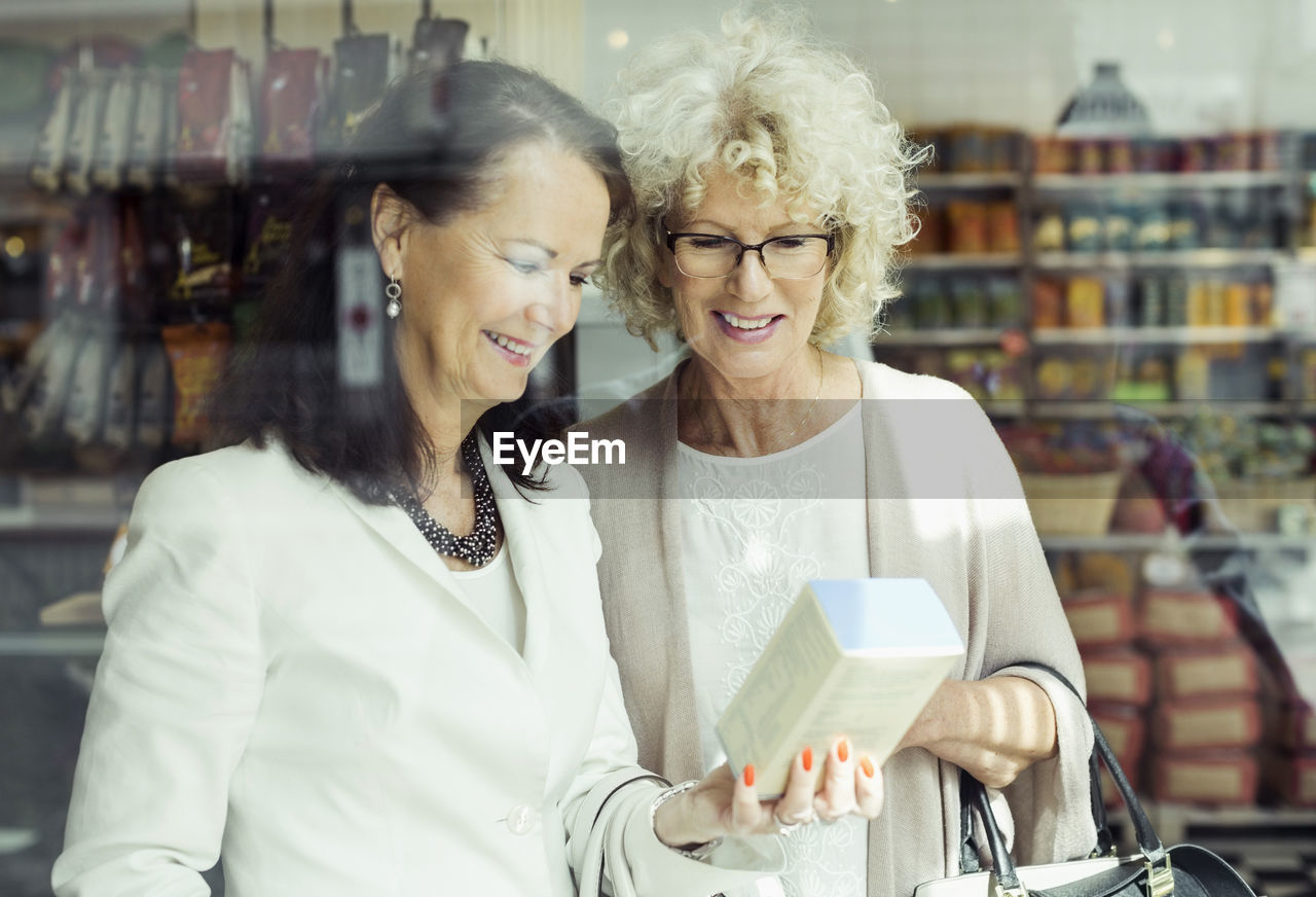 Senior women checking instructions on product in store