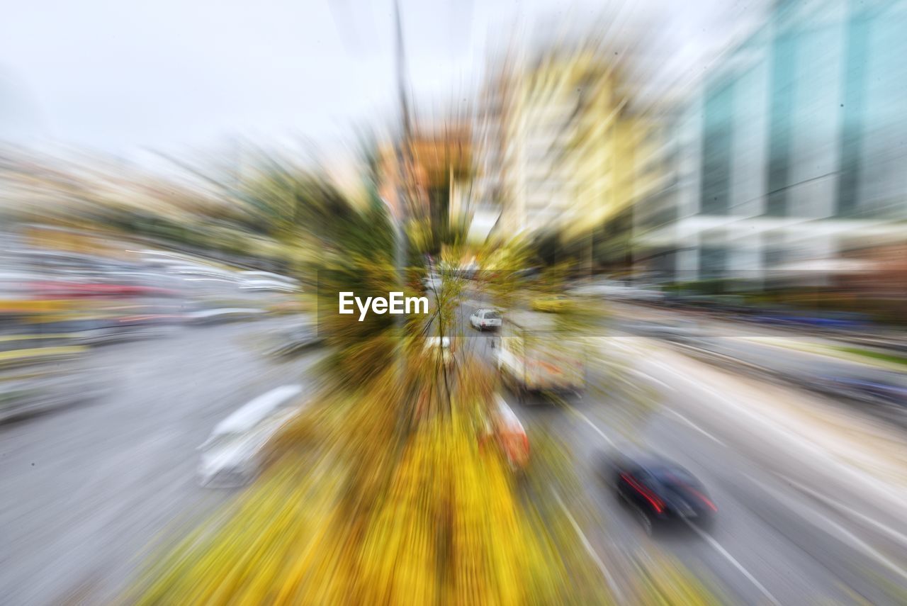Zoom in image of vehicles on street in city