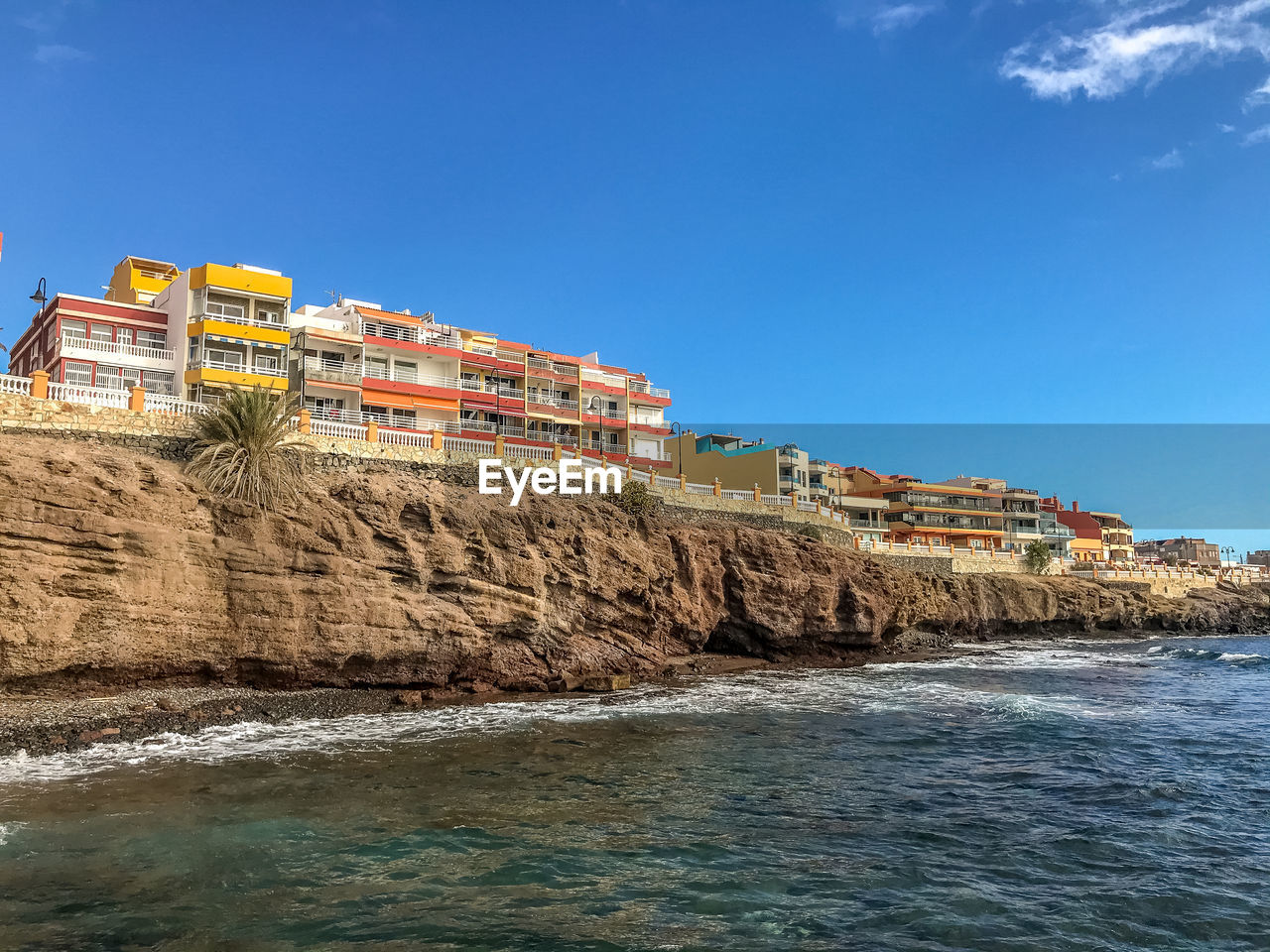 BUILDINGS BY SEA AGAINST CLEAR SKY