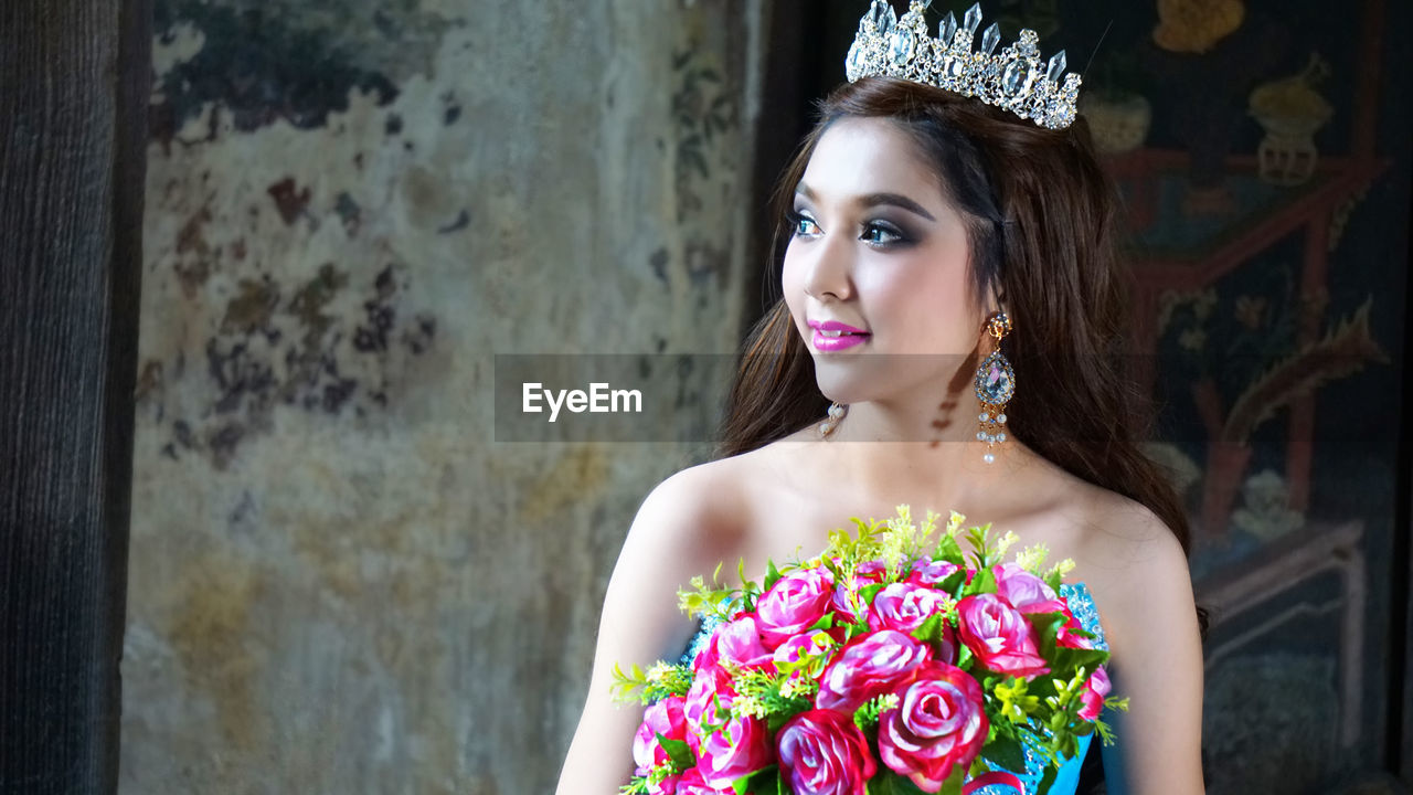 Beautiful woman holding flower bouquet