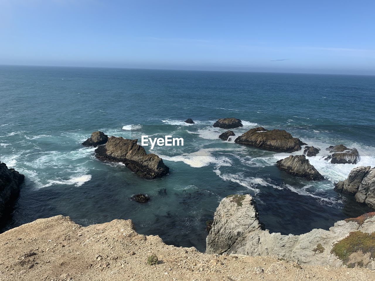 ROCKS ON SEA SHORE AGAINST SKY