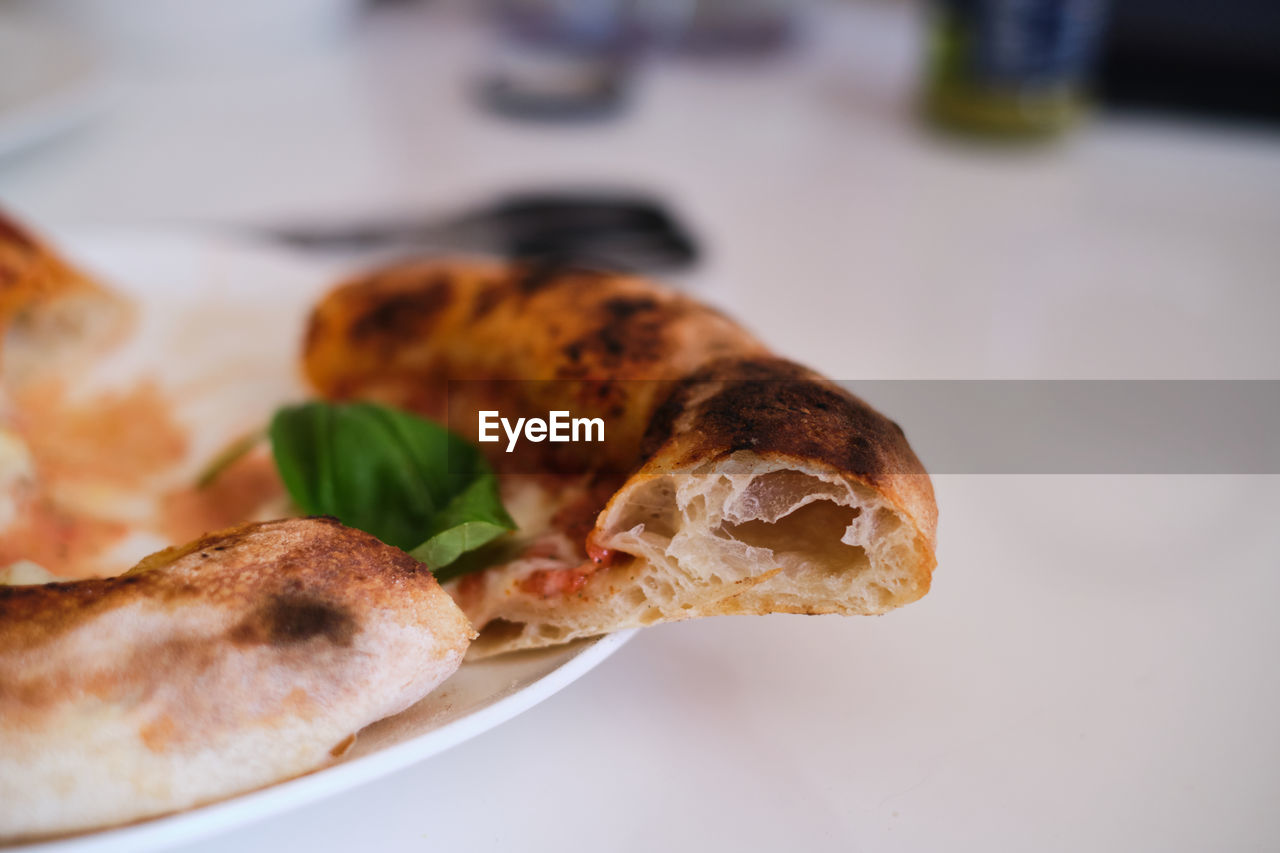 Close-up of pizza crust served in plate