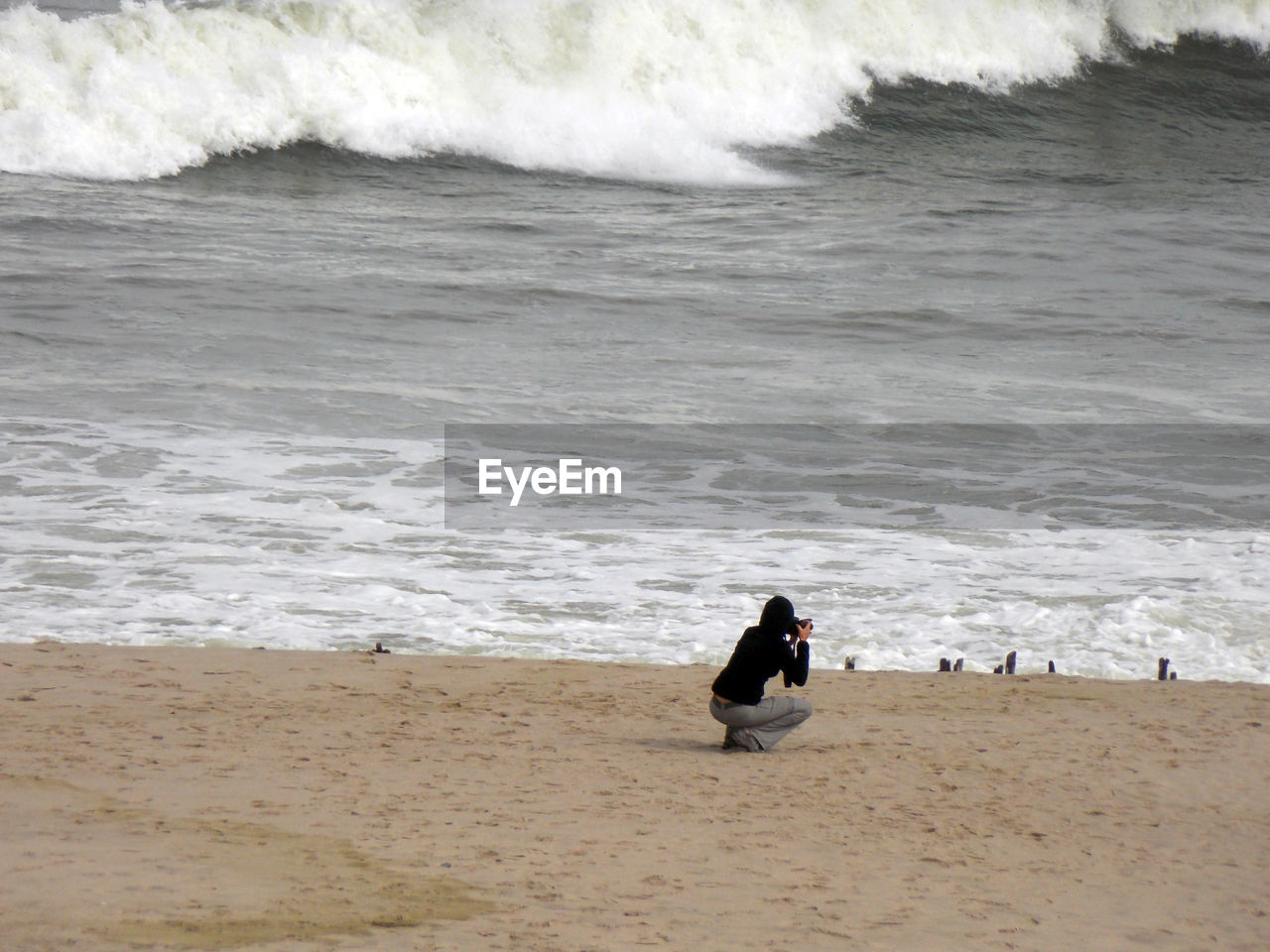 PEOPLE SITTING AT BEACH