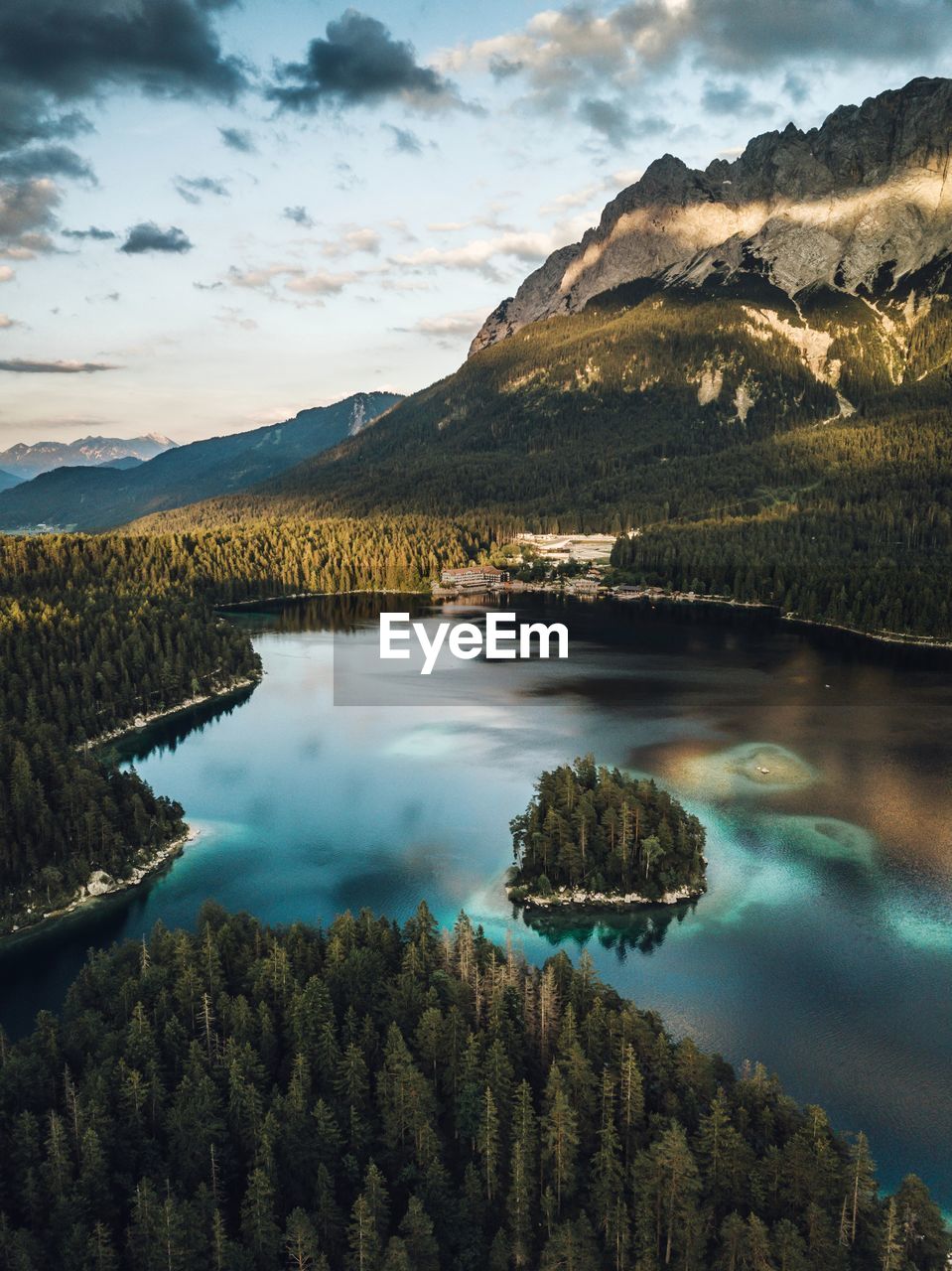 Scenic view of lake by mountains against sky