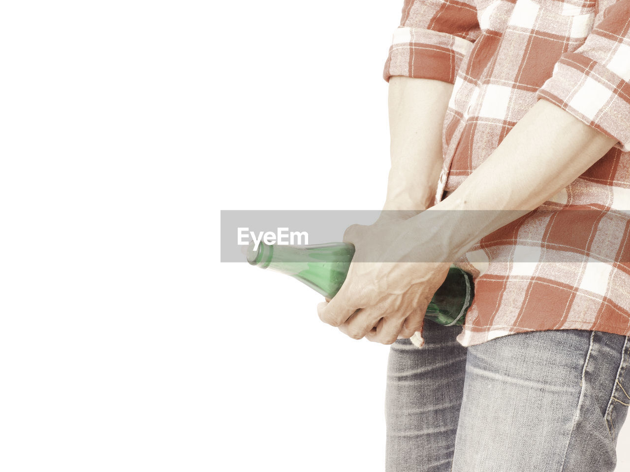 MIDSECTION OF WOMAN HOLDING HANDS AGAINST WHITE BACKGROUND