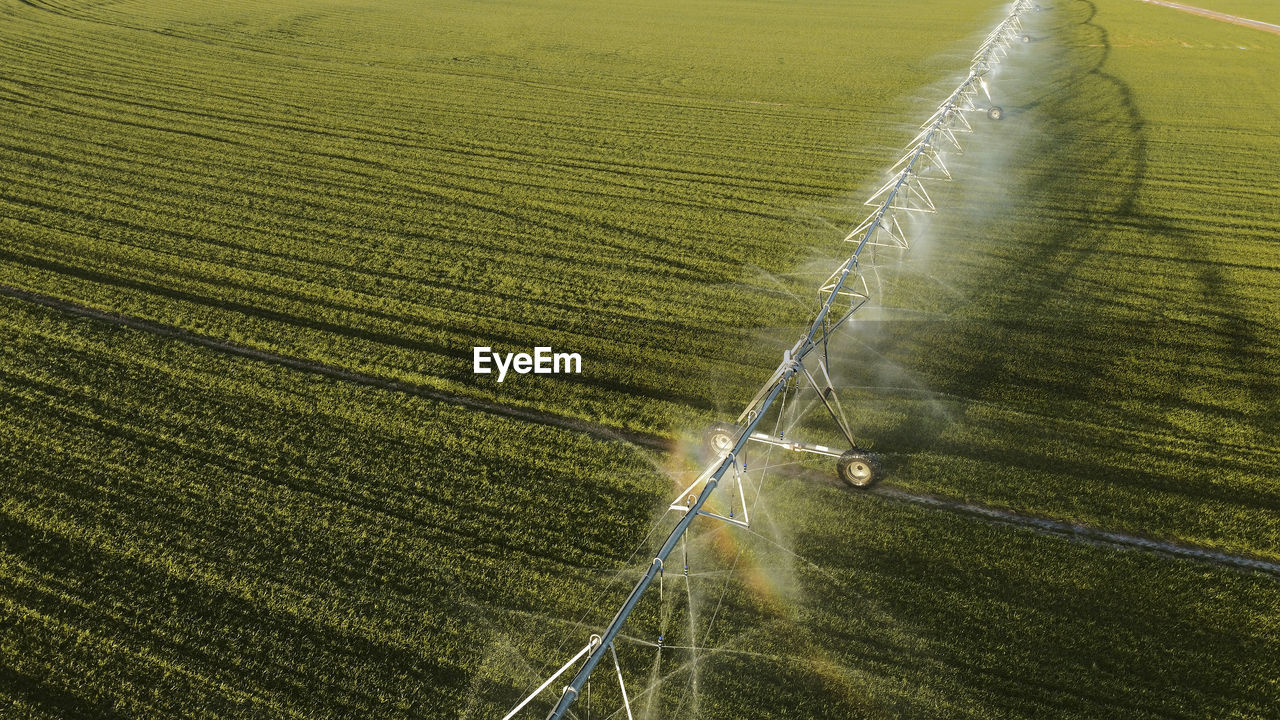 Aerial view of agricultural sprinkler spraying field