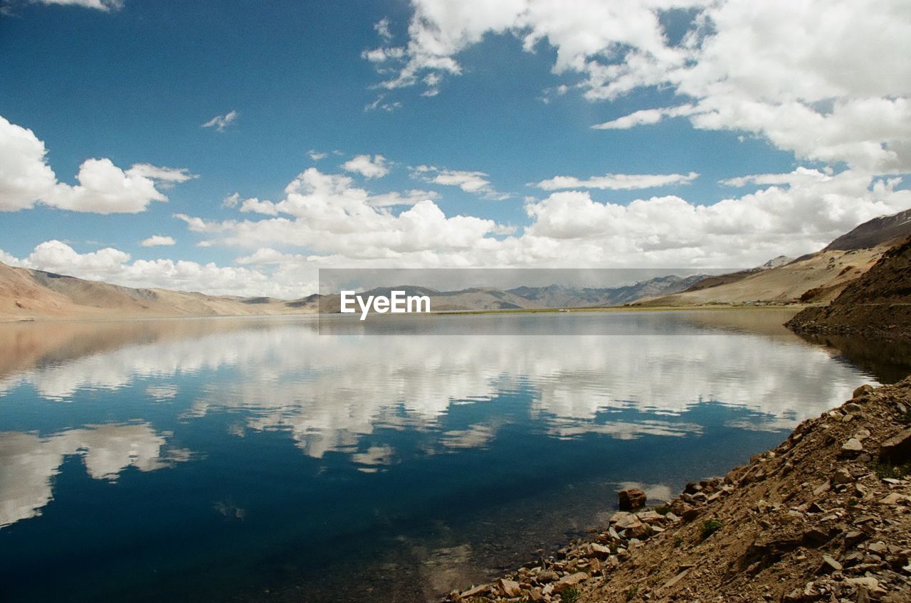 SCENIC VIEW OF LAKE AGAINST CLOUDY SKY