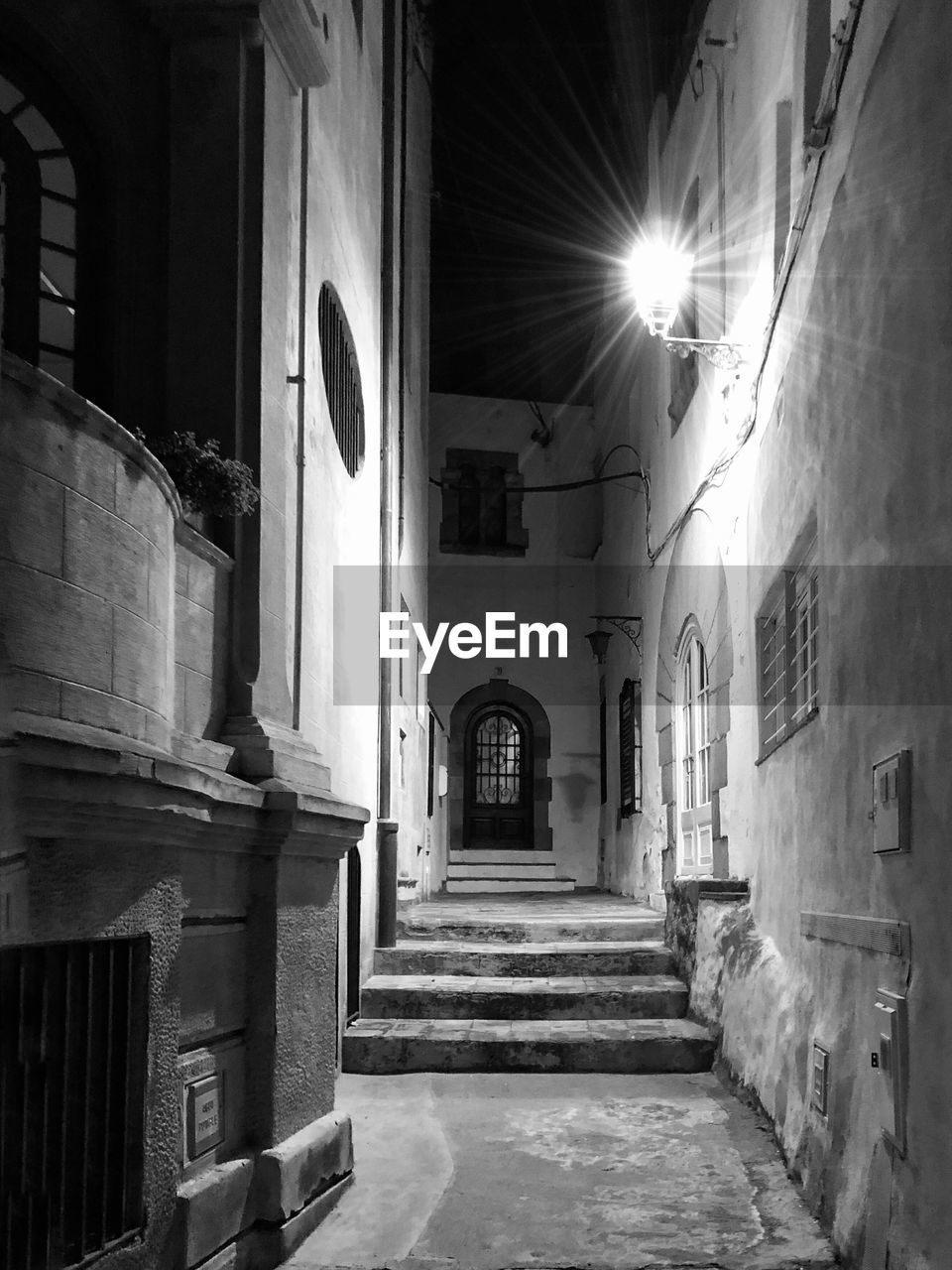 architecture, alley, darkness, road, street, white, built structure, black, monochrome, black and white, light, monochrome photography, building, building exterior, infrastructure, the way forward, no people, staircase, old, sunlight, house, city, history, lighting equipment, the past, outdoors, residential district