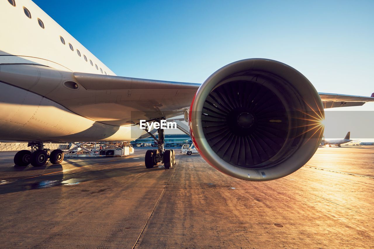 Airplane on runway against sky