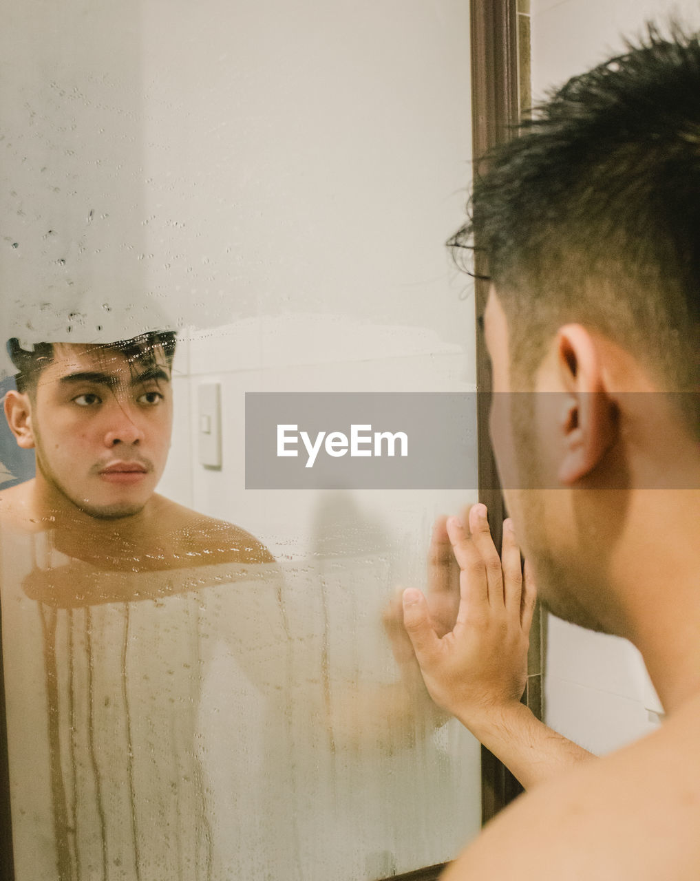 Young man looking at mirror