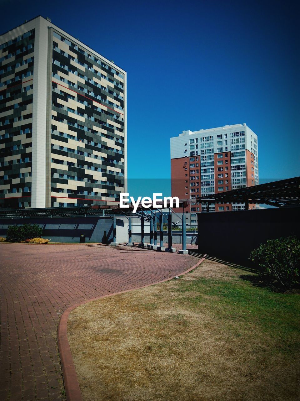 MODERN BUILDINGS AGAINST CLEAR BLUE SKY