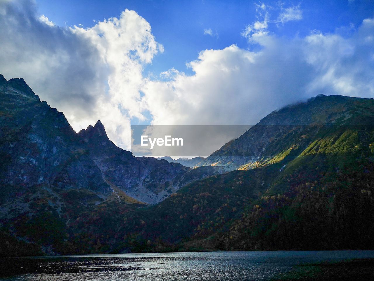 Scenic view of mountains against cloudy sky