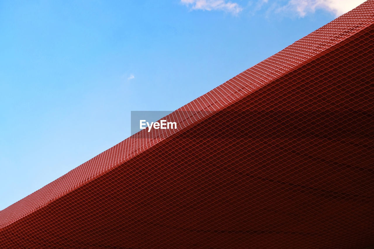 Low angle view of roof against blue sky