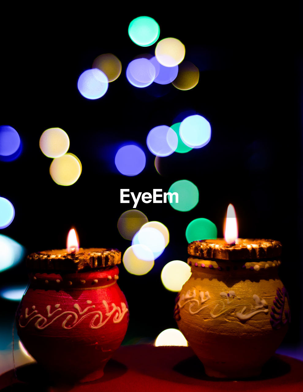 CLOSE-UP OF ILLUMINATED CANDLES ON DISPLAY