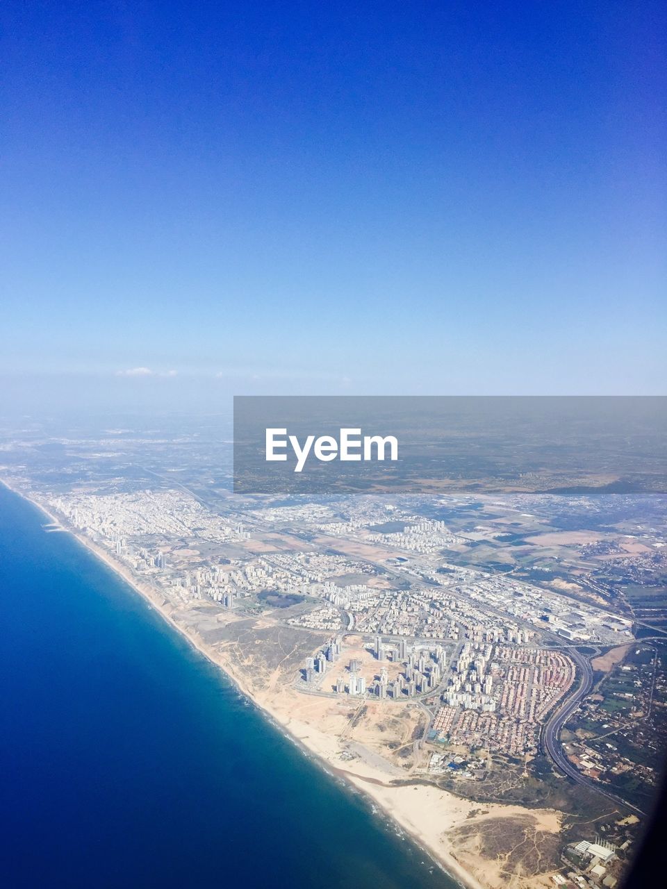 AERIAL VIEW OF CITYSCAPE SEEN THROUGH AIRPLANE