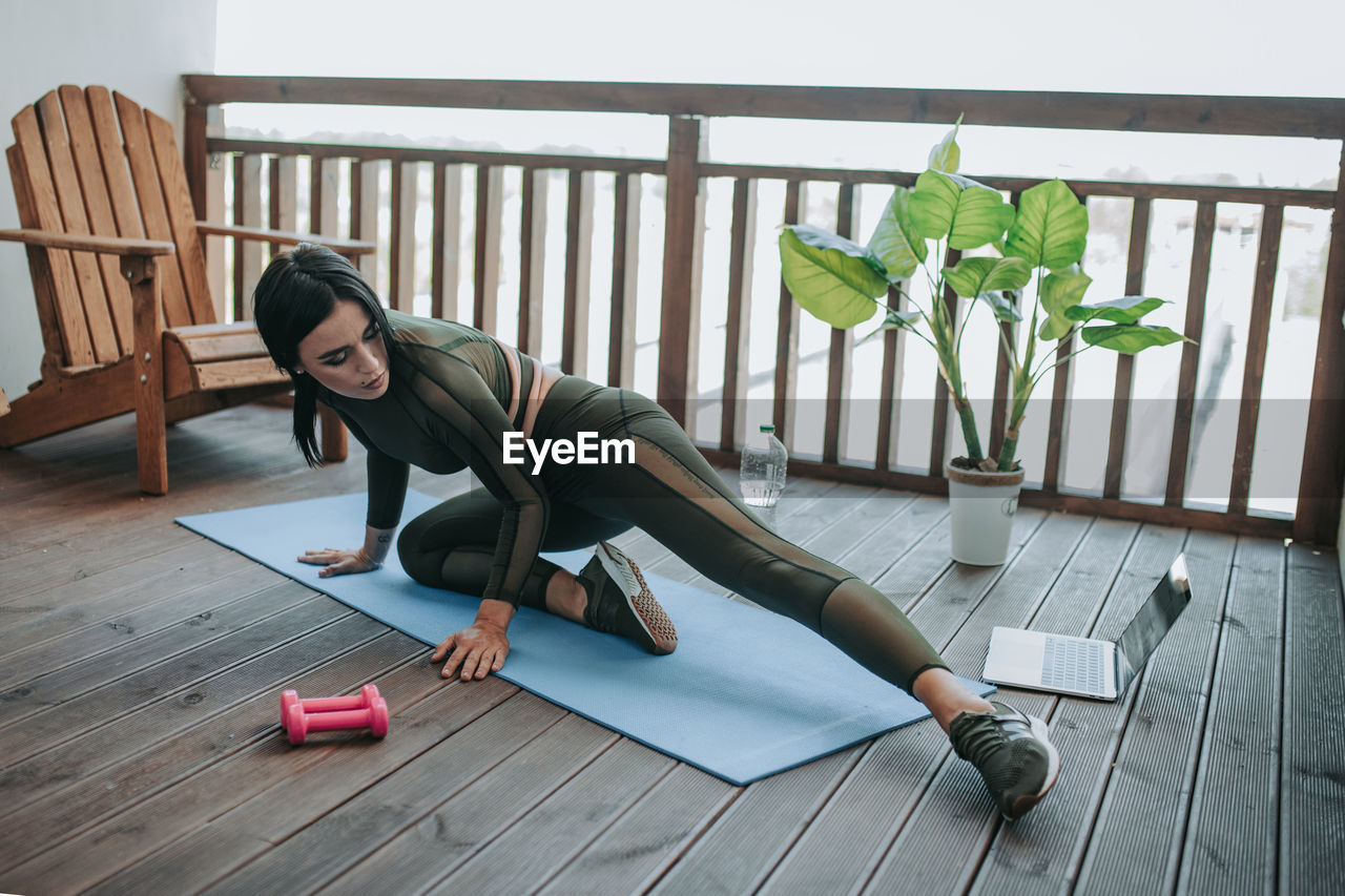 Woman sitting on wooden floor