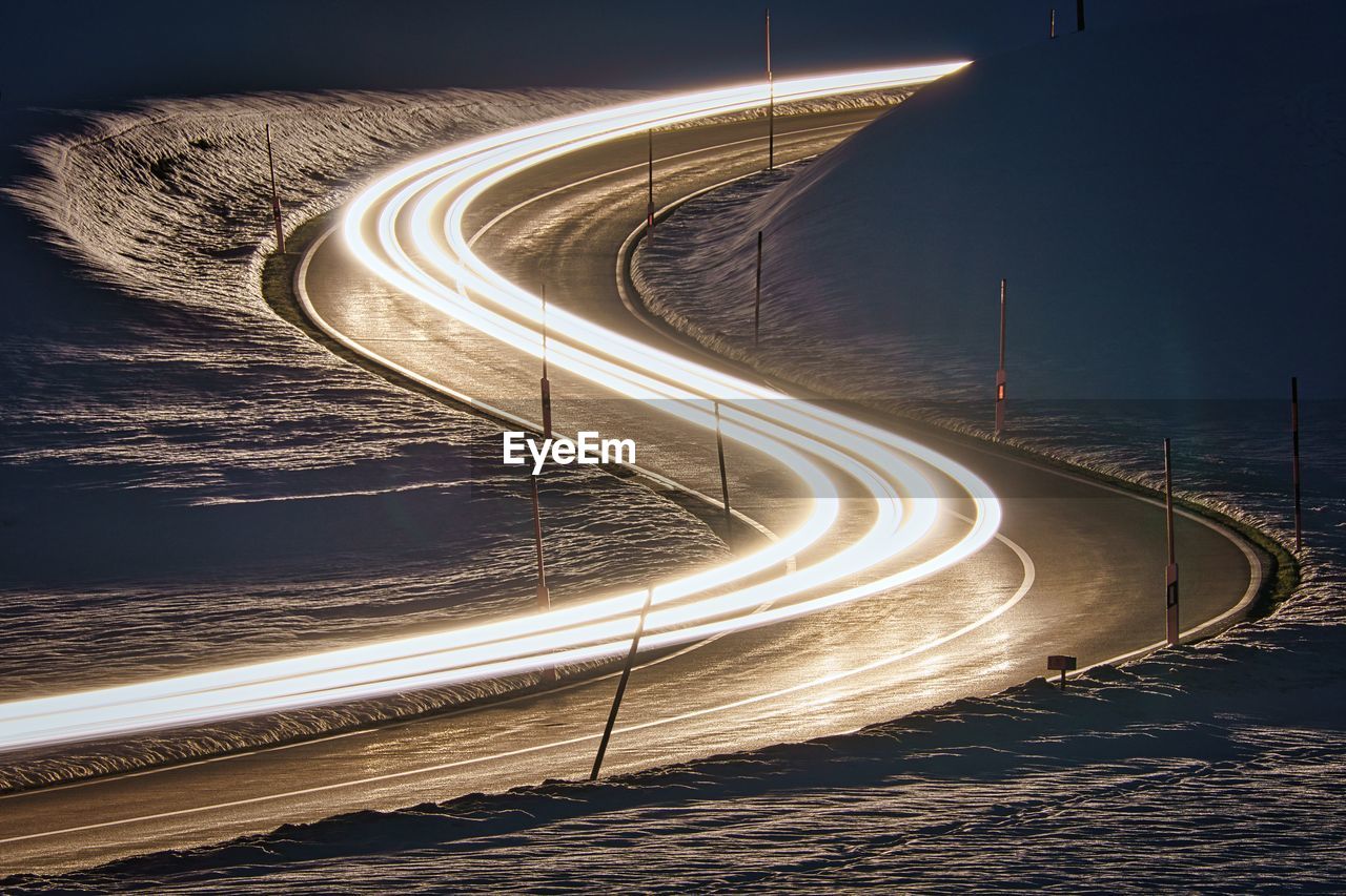 High angle view of light trails on road at night