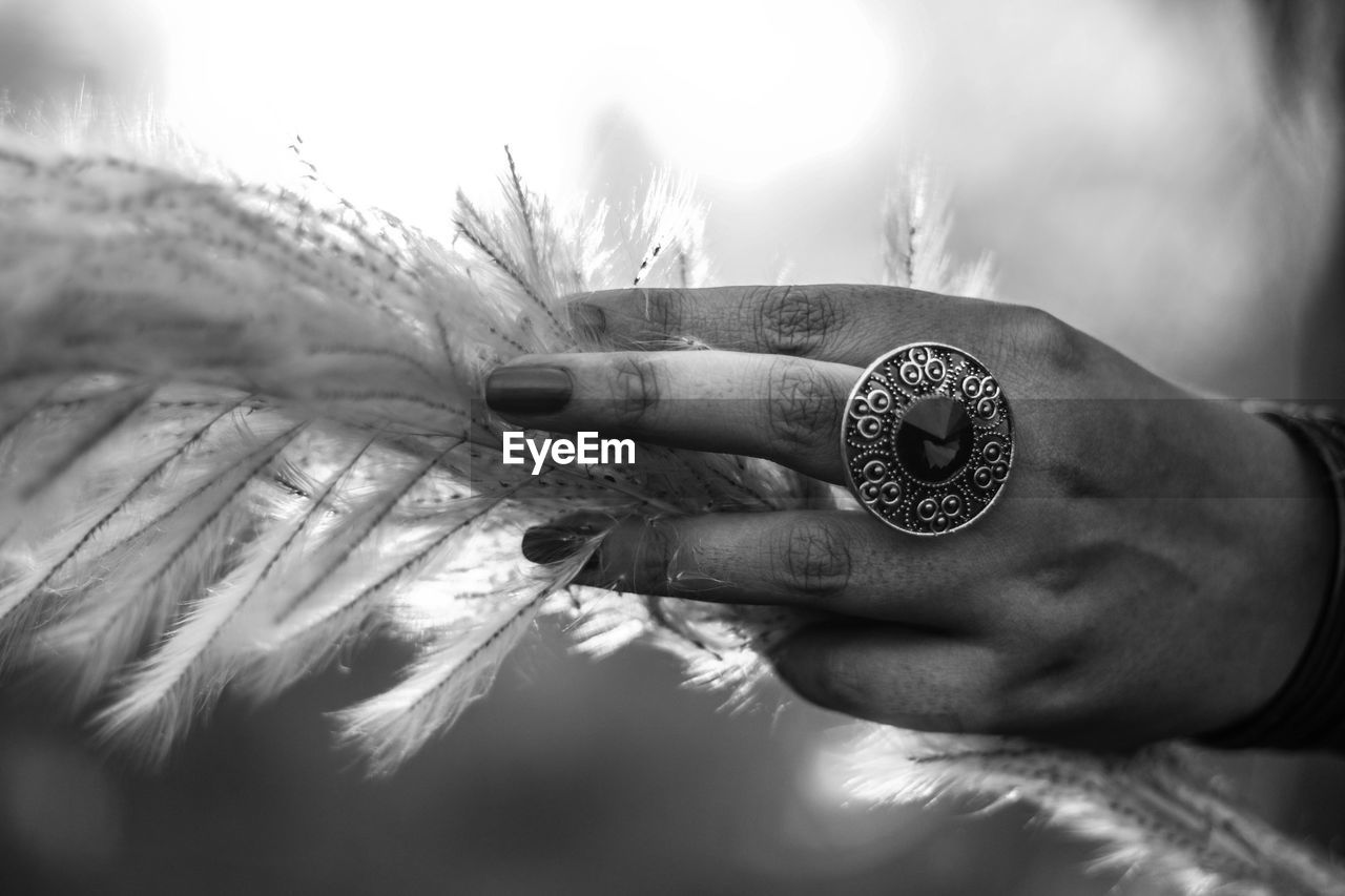 CLOSE-UP OF HUMAN HAND HOLDING CAMERA