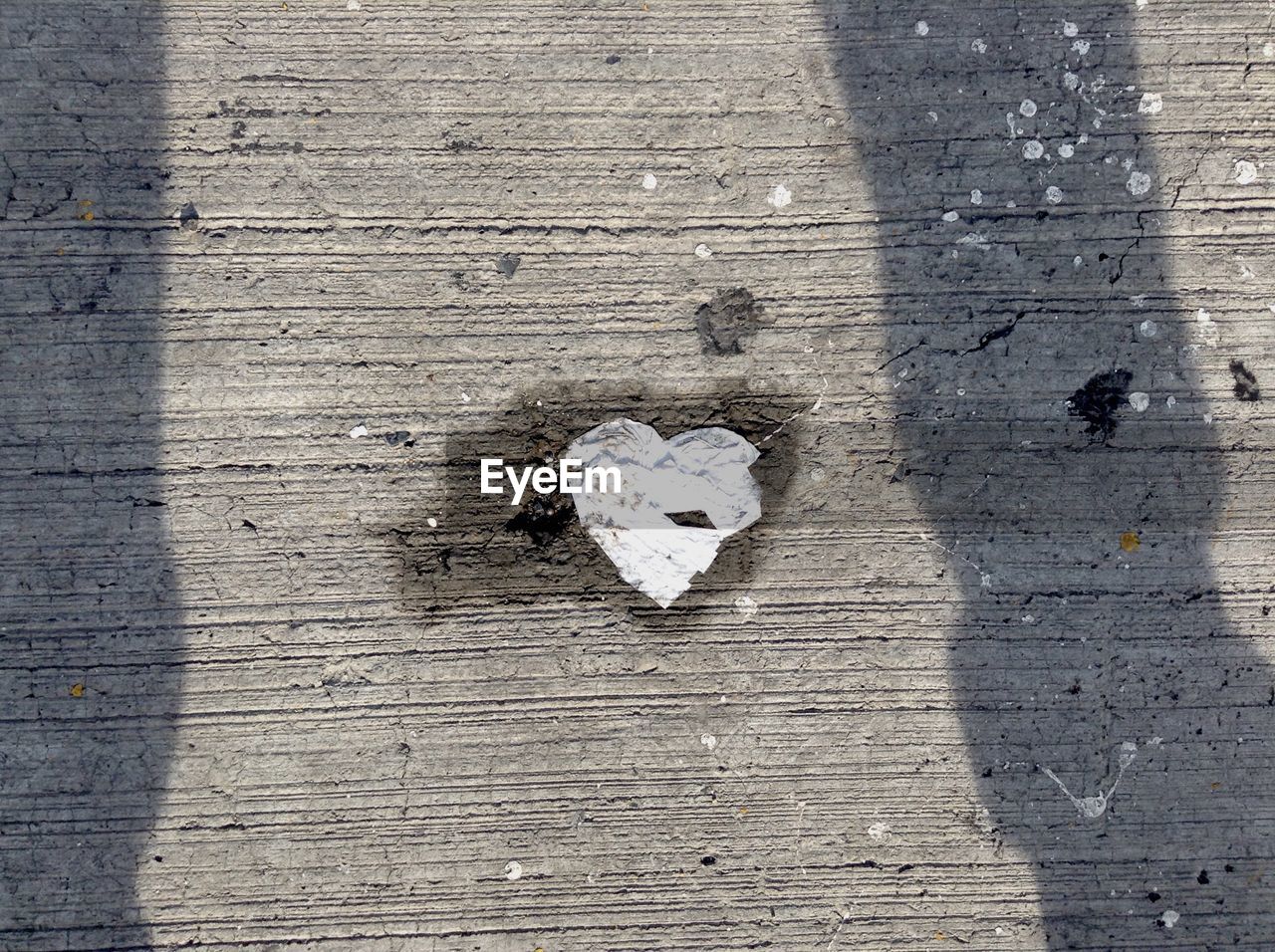 High angle view of heart shape of paper on footpath