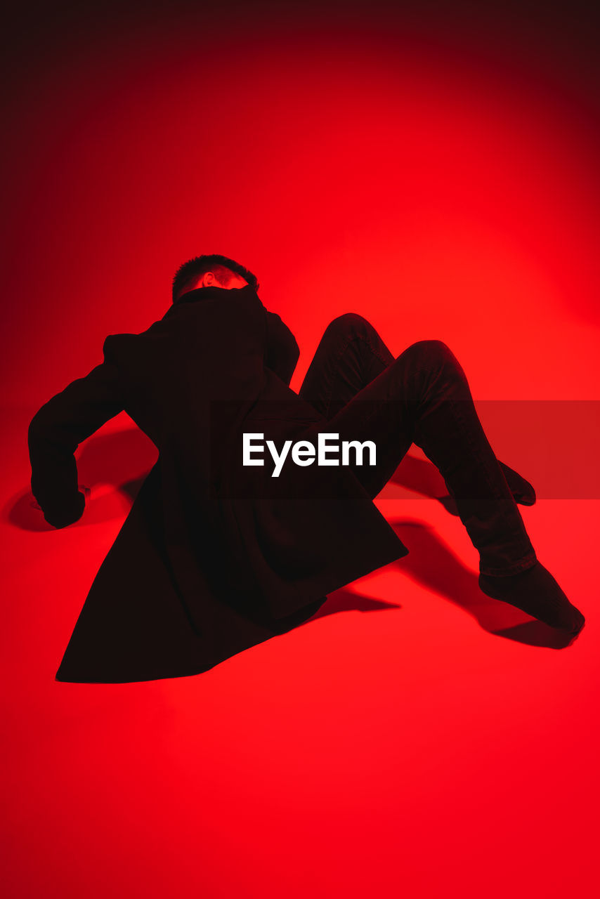High angle view of man posing against red background