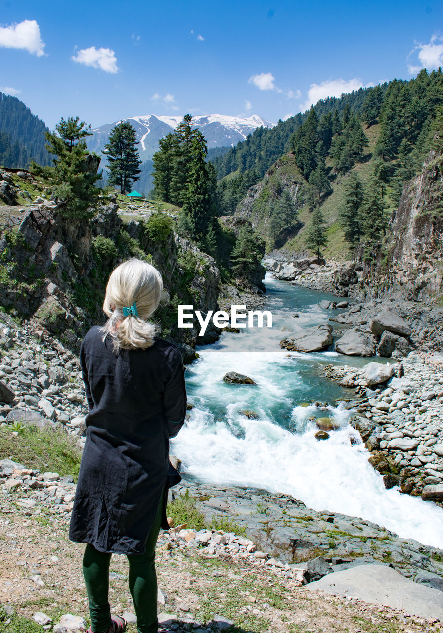 Rear view of woman walking on mountain
